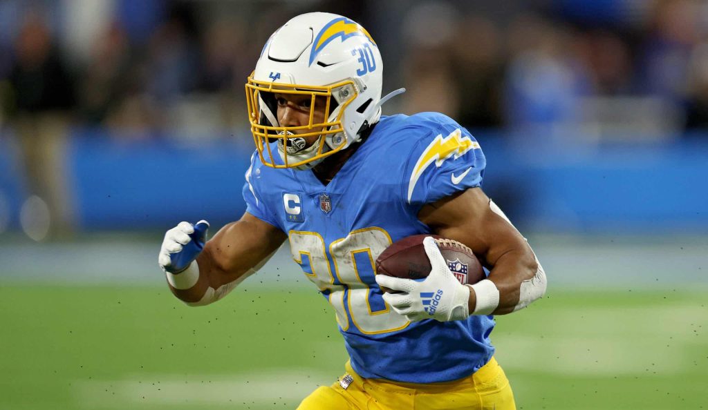 Austin Ekeler #30 of the Los Angeles Chargers rushes in the first quarter during a game against the Miami Dolphins at SoFi Stadium on December 11, 2022 in Inglewood, California.