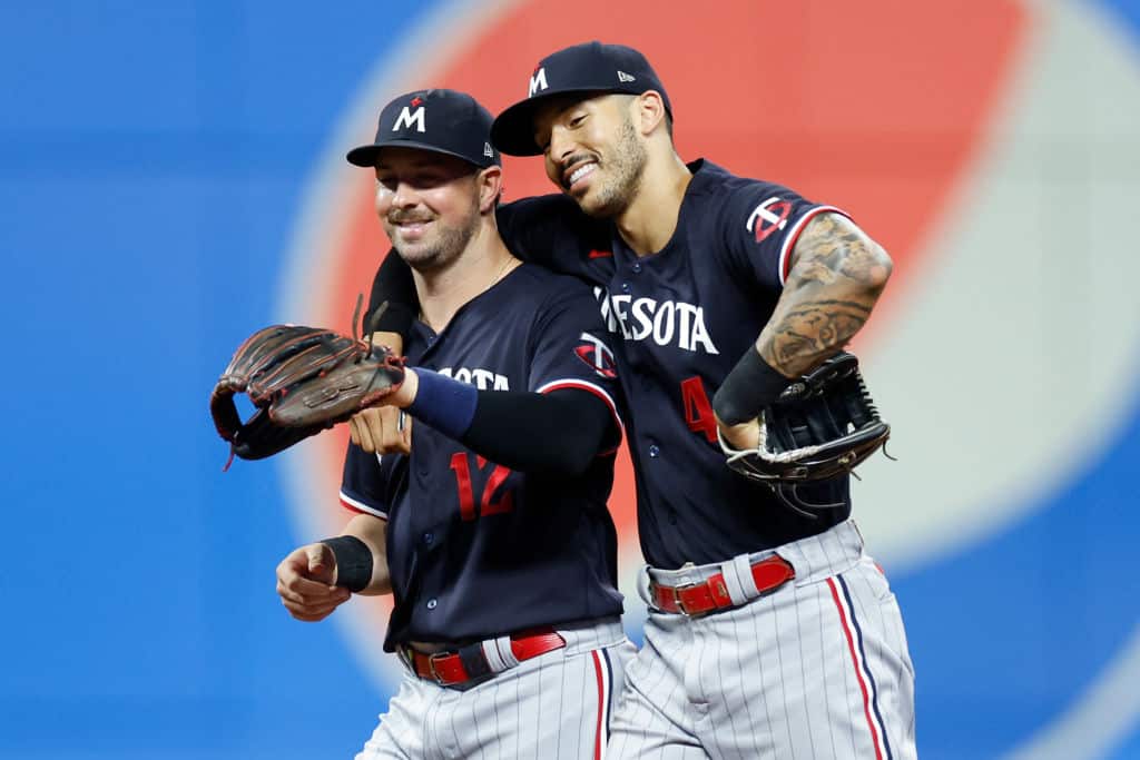 Kyle Farmer #12 and Carlos Correa #4 of the Minnesota Twins celebrate an 8-3 win against the Cleveland Guardians at Progressive Field on September 05, 2023 in Cleveland, Ohio.